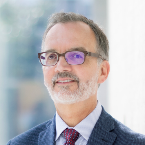 Photo of Professor Trevor Young wearing a blue jacket and burgundy tie